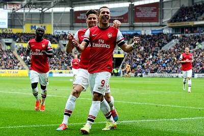 Lukas Podolski strikes twice as Arsenal glide past Hull