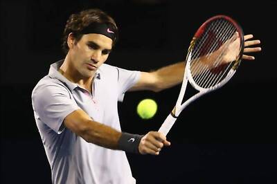 Federer brushes aside Raonic to enter quarter-finals