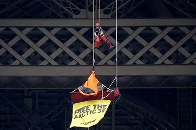 Greenpeace activist dangles from Eiffel Tower in Russia protest