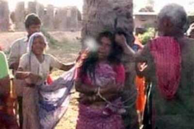 Widow garlanded with shoes for praying at a temple