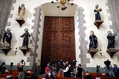 Faithful return to Mexico City churches with masks, gel