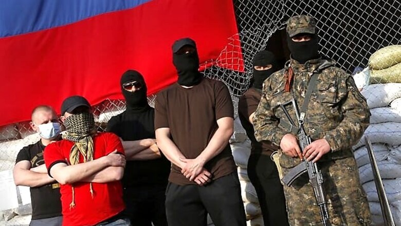 Observers held in Ukraine speak under armed guard