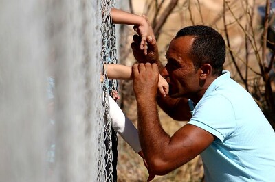 Apart For a Year, Syrian Family Shares Kisses Through Fence
