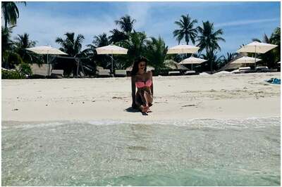 Disha Patani Flaunts Tanned Body as She Poses By the Beach in Pink Bikini