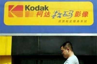 Kodak posts loss, cuts revenue outlook